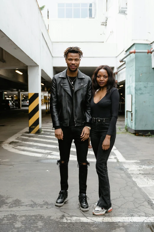 a man and a woman standing in a parking garage, an album cover, pexels contest winner, black leather slim clothes, black people, instagram story, cast