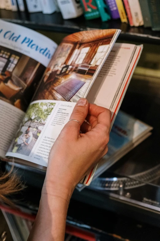 a woman is reading a book in a library, a picture, by Jan Tengnagel, private press, magazine design, up close shot, thumbnail, travel guide