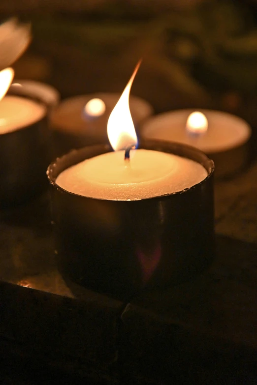 a group of lit candles sitting on top of a table, medium detail, slate, most popular, close shot