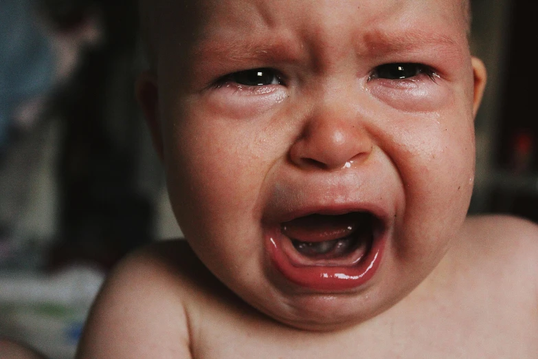 a crying baby sitting on top of a bed, pexels, closeup of face melting in agony, an angry, red tears, crying engine