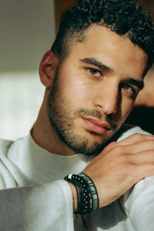 a close up of a person wearing a watch, an album cover, inspired by Nadim Karam, photorealism, zayn malik, handsome and attractive, lgbtq, square masculine jaw