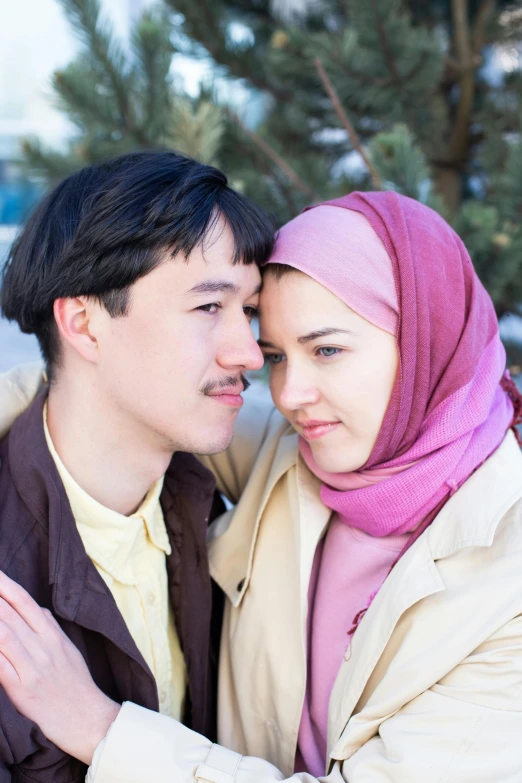 a man and a woman standing next to each other, a picture, shutterstock, hurufiyya, dilraba dilmurat, wearing a scarf, lesbians, 2005