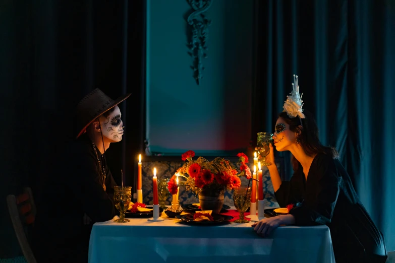 a couple of people sitting at a table with candles, by Julia Pishtar, pexels contest winner, vanitas, dia de los muertos makeup, gentlemens dinner, ready to eat, profile image