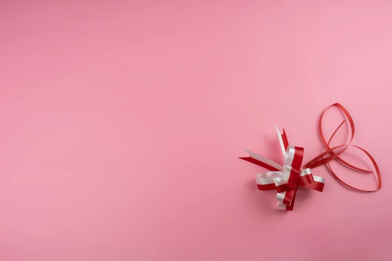 a red and white bow on a pink background, by Emma Andijewska, pexels contest winner, background image, opening shot, love theme, 8k 4k