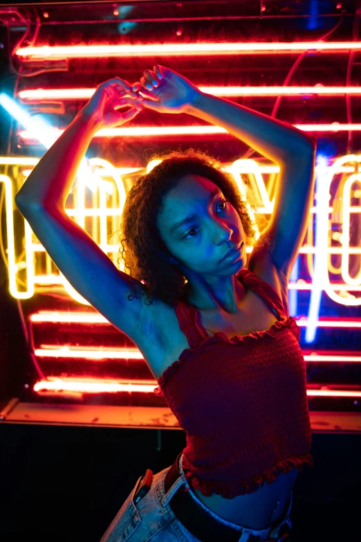 a woman standing in front of a neon sign, pexels contest winner, renaissance, ashteroth, nightclub dancing inspired, low saturated red and blue light, black young woman