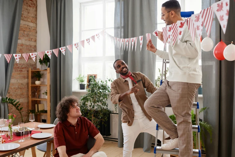 a group of men standing on top of a wooden table, pexels contest winner, happening, red pennants, joyful people in the house, coworkers, people dancing