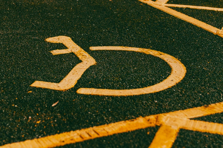 a parking lot with a handicap sign painted on it, trending on pexels, graffiti, square, gold, educational, speed lines