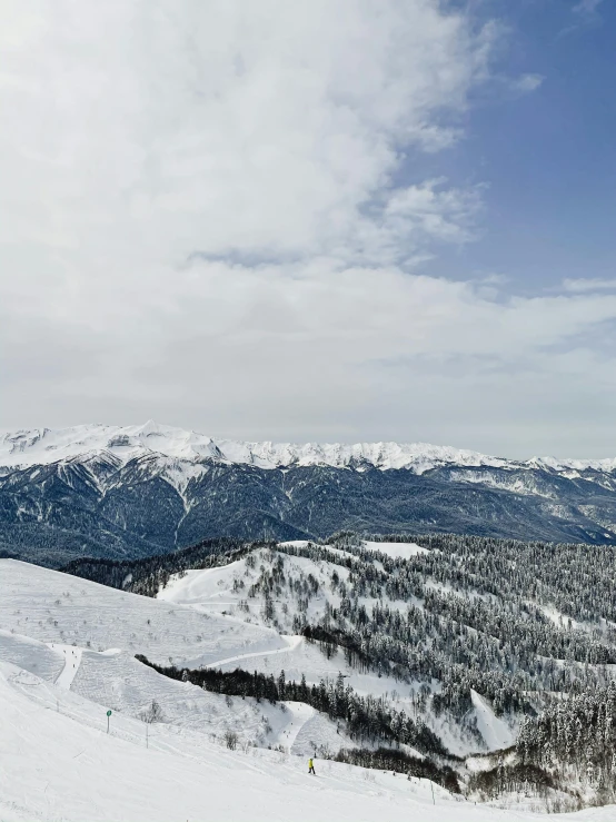 a man riding a snowboard down the side of a snow covered slope, pexels contest winner, overlooking a valley with trees, panorama, listing image, 8 k photo