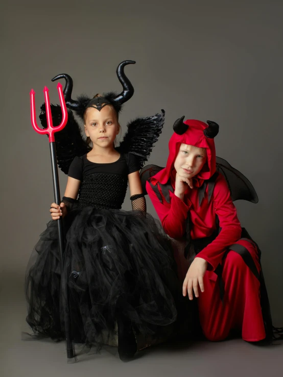 two little girls dressed up as devil and devil, pexels contest winner, international gothic, with black, high resolution product photo, children's, various posed