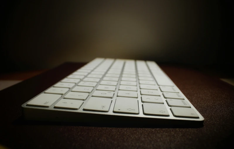 a close up of a keyboard on a table, a computer rendering, pexels, computer art, gradient brown to white, square, nighttime, low-angle shot