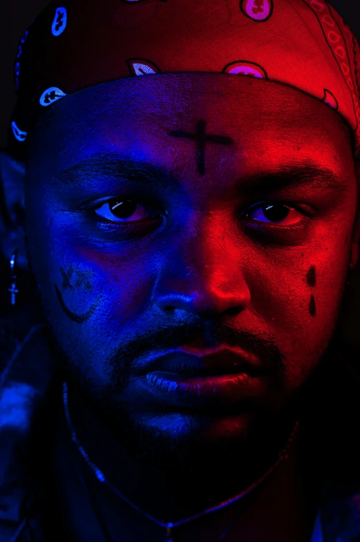 a man with black light on his face, an album cover, ((red)) baggy eyes, teddy fresh, close up portrait shot, cross-eyed