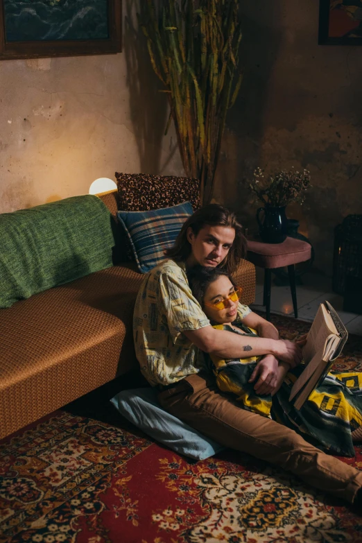 a man sitting on the floor with a baby in his lap, a portrait, by Jan Tengnagel, pexels contest winner, renaissance, couple on bed, hippie pad, couch, promotional image