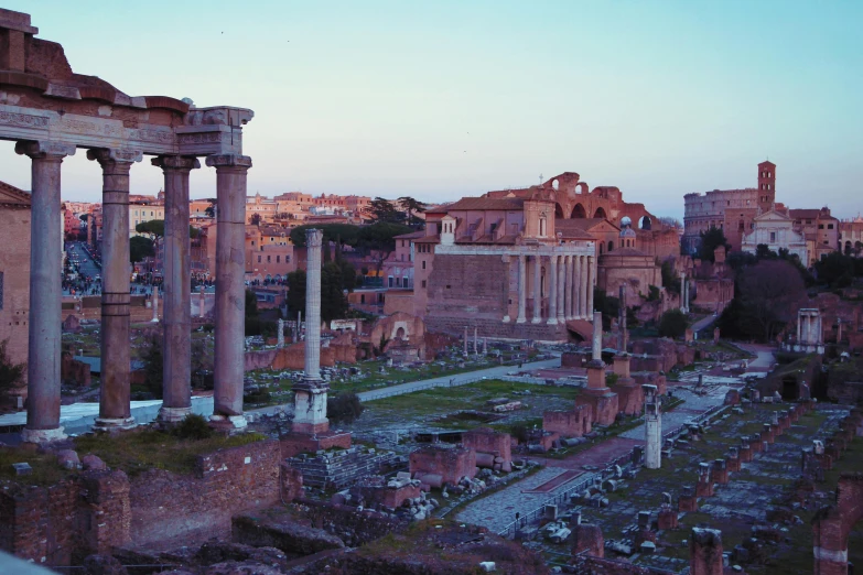 a view of the ruins of a roman city, pexels contest winner, neoclassicism, evening light, 1960s color photograph, grey