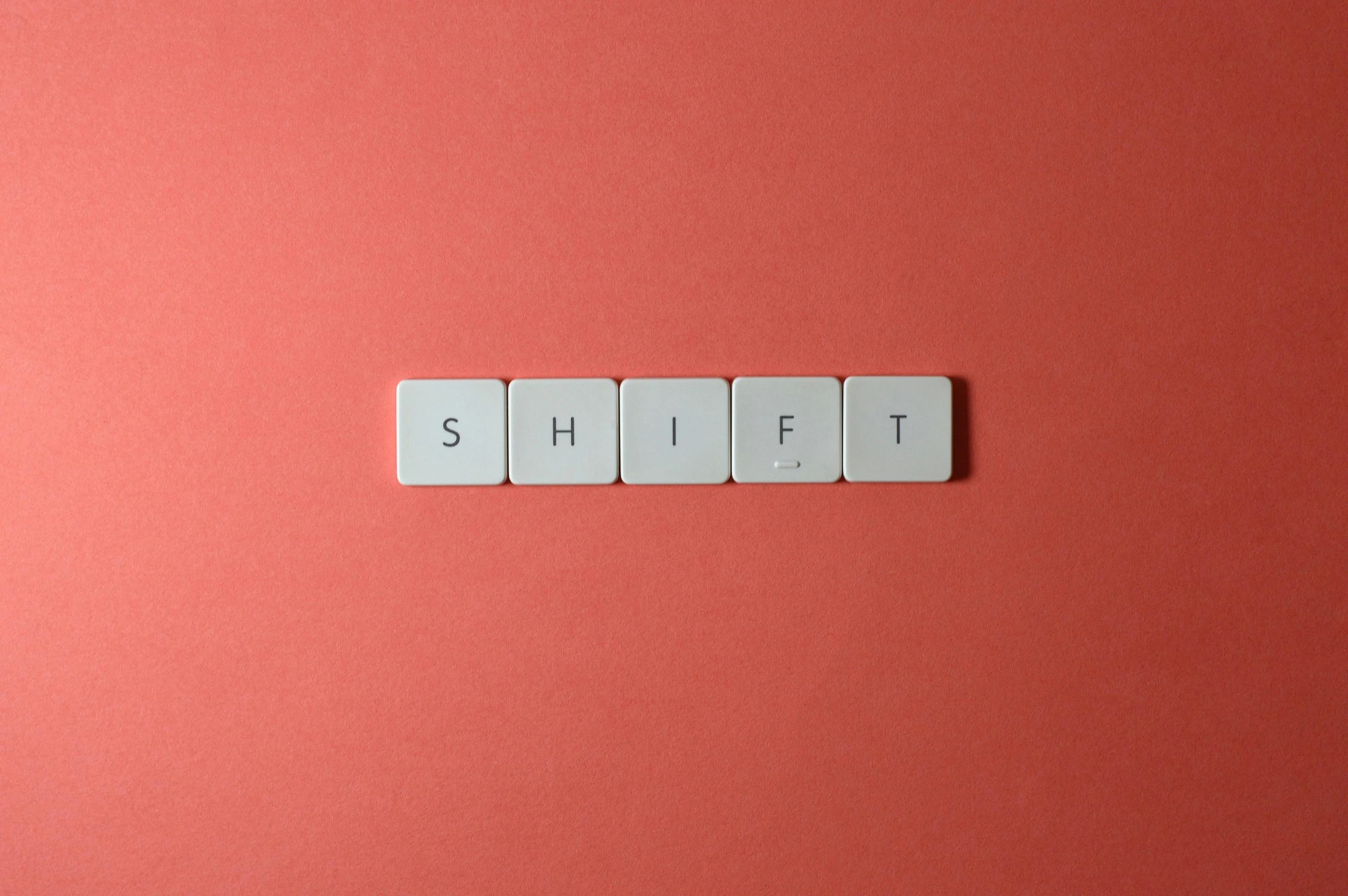 the word shift spelled in white tiles on a pink background, an album cover, by Sylvia Wishart, trending on unsplash, mechanical keyboard, red shift, thumbnail, half - turn