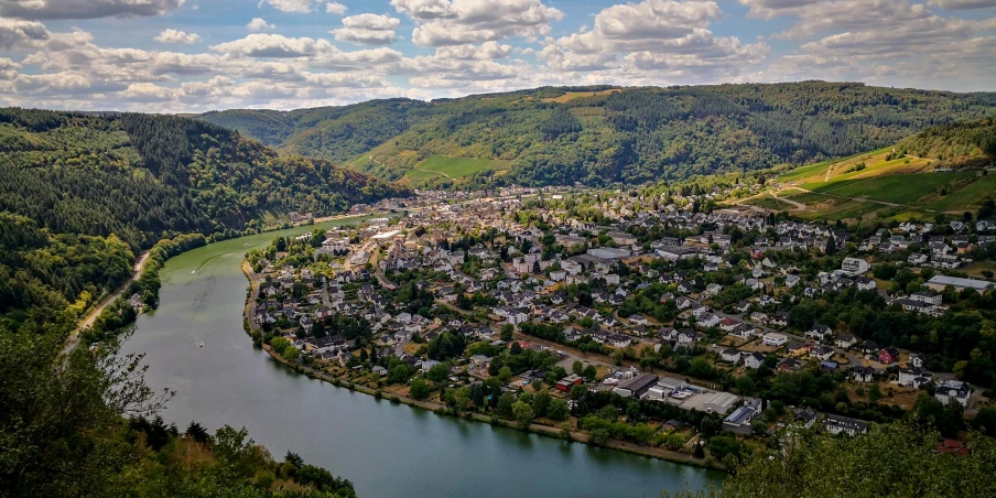 a river running through a lush green valley, by Breyten Breytenbach, pexels contest winner, renaissance, in the foreground a small town, rossier, panoramic, slide show