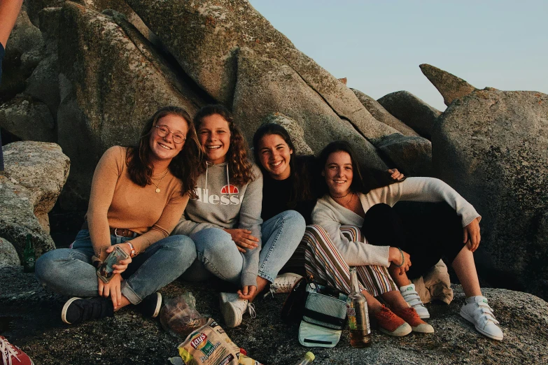 a group of women sitting on top of a pile of rocks, pexels contest winner, picnic, avatar image, high school, profile image