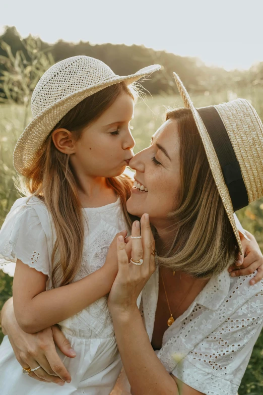 a woman and a little girl in a field, pexels contest winner, white straw flat brimmed hat, kissing each other, softly lit, transparent background