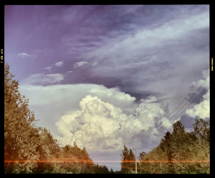 there is a large cloud that is in the sky, a picture, by Jan Rustem, colored photo, near forest, cinematic shot ar 9:16 -n 6 -g, washed out color