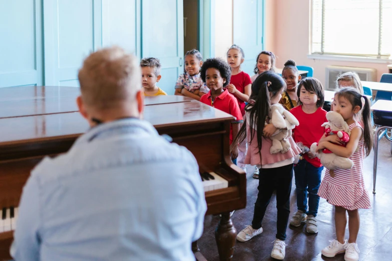 a group of children standing around a piano, pexels, photo of a classroom, edu souza, sing with me, premium quality