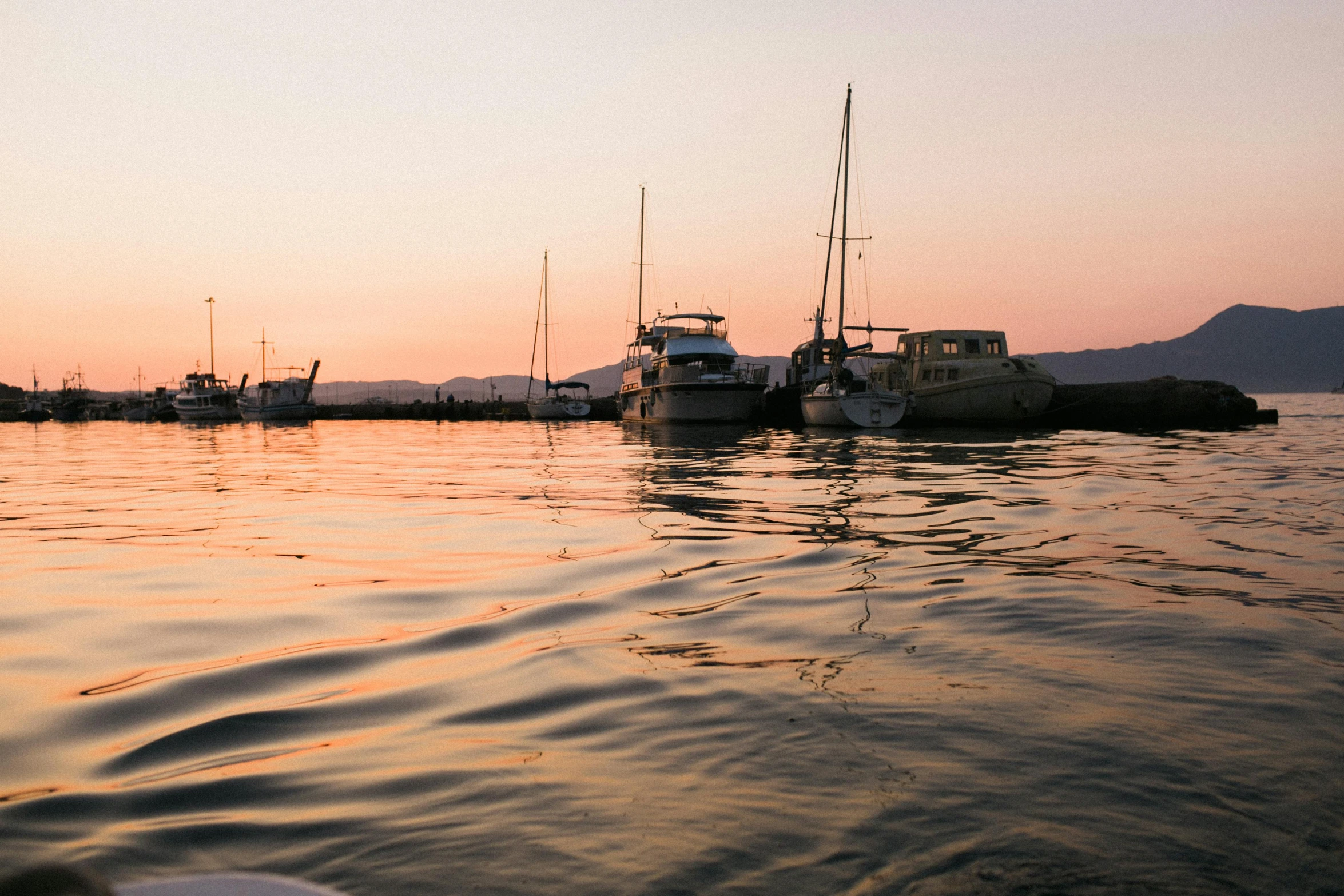 a number of boats in a body of water, by Tom Bonson, pexels contest winner, pink golden hour, lachlan bailey, view from the side”, subtle details