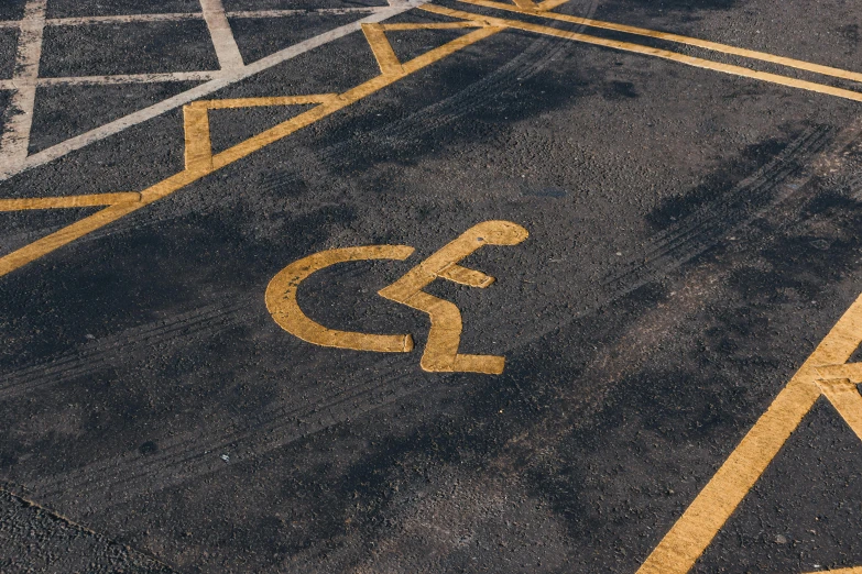a parking lot with a handicap sign painted on it, trending on pexels, auto-destructive art, square, lane brown, gold, high-quality photo