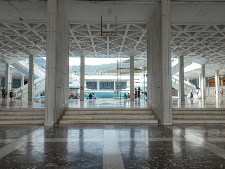 a group of people that are standing in a building, a marble sculpture, art deco stadium, greek pool, corridor, viewed from afar