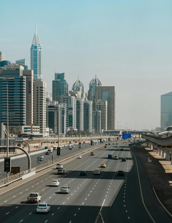 a highway filled with lots of traffic next to tall buildings, pexels contest winner, hyperrealism, dubai, 2 0 2 2 photo, billboard image, 2000s photo