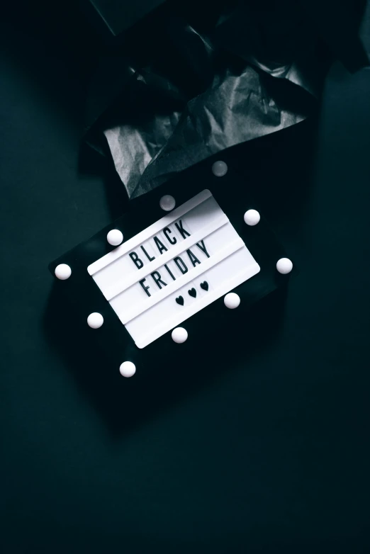 a black friday sign sitting on top of a table, trending on unsplash, thumbnail, ( ( theatrical ) ), profile image, presents