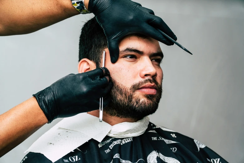 a man getting his hair cut at a barber shop, by Julia Pishtar, trending on pexels, square masculine facial features, tom of finland style, slicked black hair, thumbnail