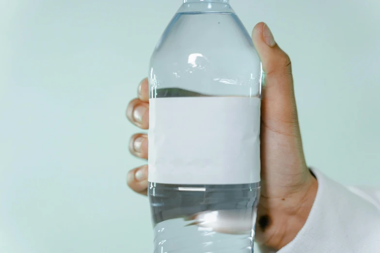 a person holding a bottle of water in their hand, listing image, rectangle, thumbnail, no text