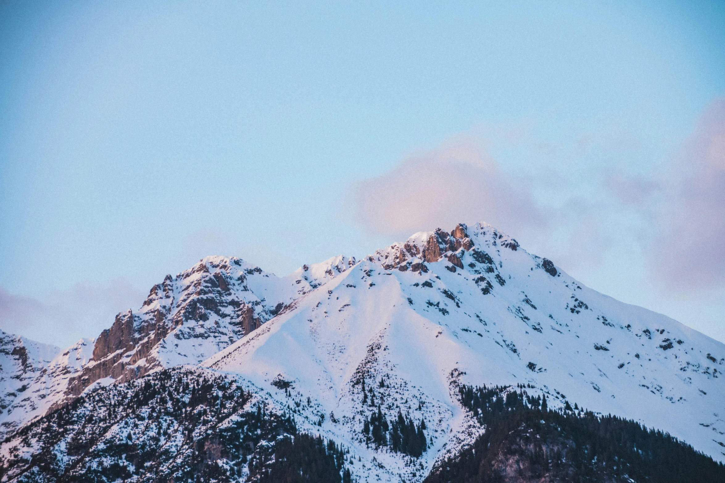 a mountain covered in snow under a blue sky, trending on unsplash, late afternoon light, high quality product image”