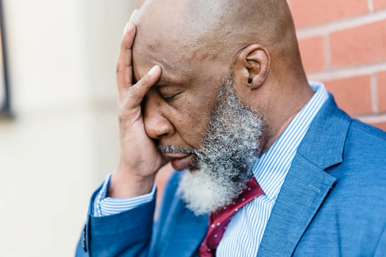 a close up of a person wearing a suit and tie, a photo, inspired by William H. Mosby, unsplash, renaissance, looking exhausted, bald head and white beard, facepalm, 45 years old men