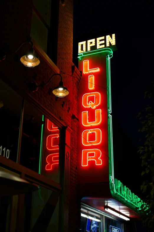 a neon sign on the side of a building, drinks, green lights, oregon, and