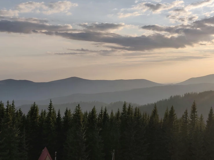 a group of people riding skis on top of a snow covered slope, by Adam Szentpétery, pexels contest winner, romanticism, late summer evening, spruce trees on the sides, distant valley, from the roof