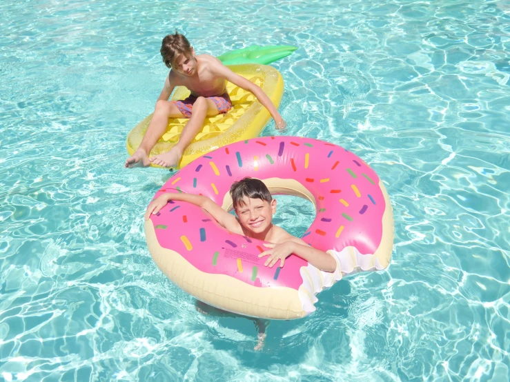 two children floating on inflatable donuts in a pool, turquoise pink and yellow, thumbnail, multicoloured, snacks