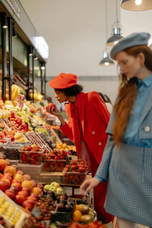 a couple of women standing in front of a fruit stand, trending on pexels, renaissance, red hat, inspect in inventory image, wearing red jacket, performance