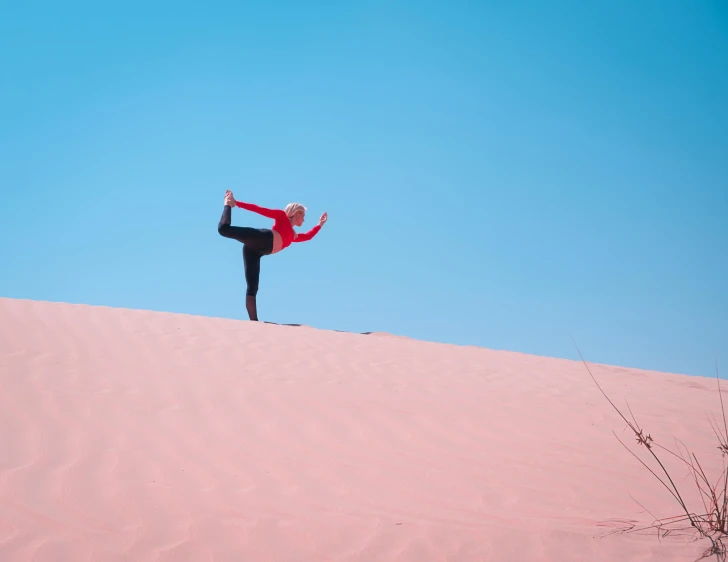 a woman doing a yoga pose in the desert, inspired by Scarlett Hooft Graafland, pexels contest winner, arabesque, shades of pink and blue, plain background, avatar image, holiday season