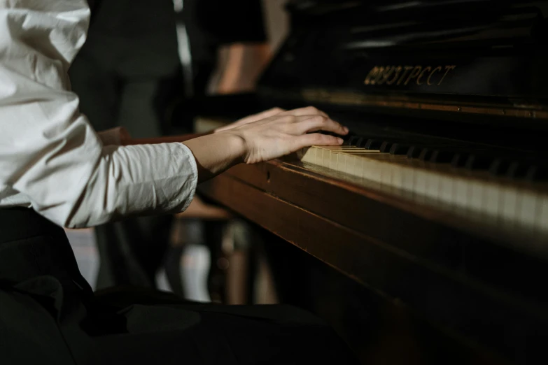 a close up of a person playing a piano, profile image, brown, individual, colour corrected