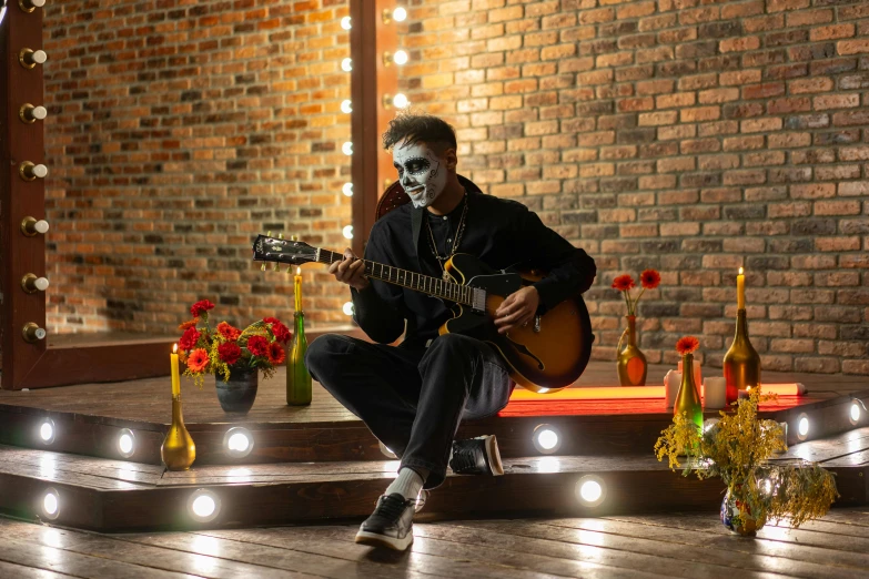 a man that is sitting down with a guitar, pexels contest winner, vanitas, haunted house themed, avatar image, dia de los muertos. 8 k, full face shot