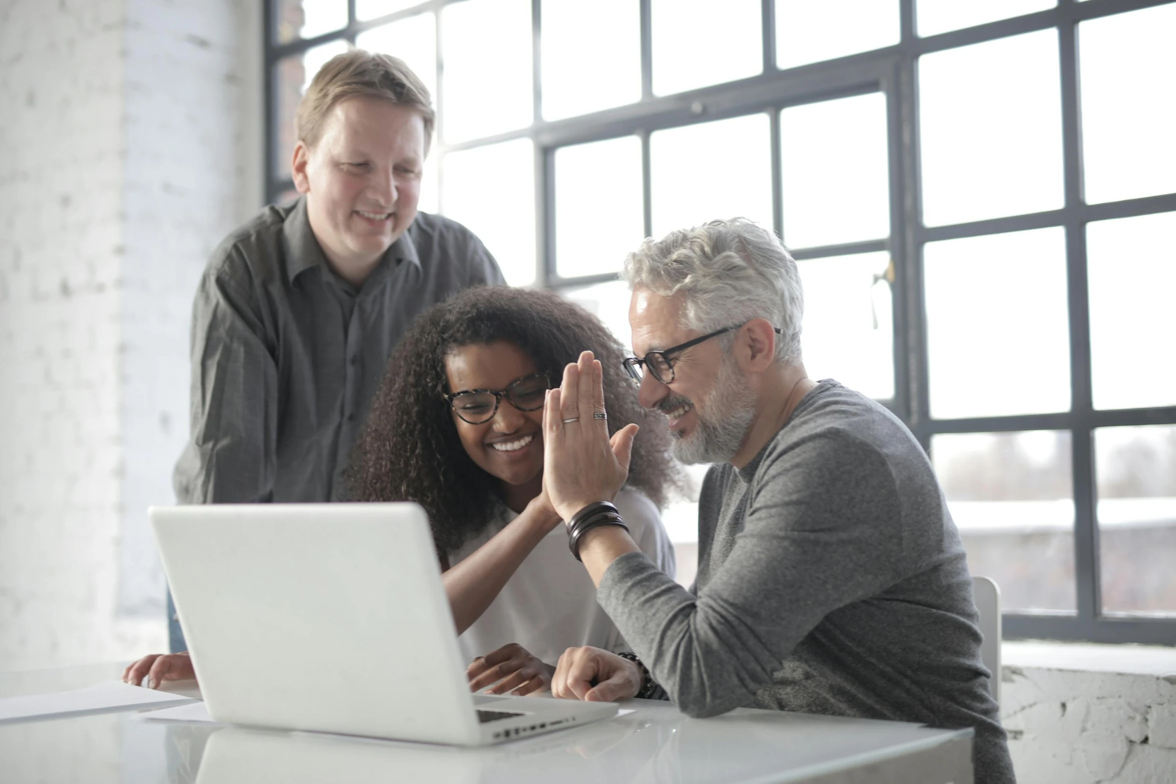 a group of people sitting around a laptop computer, grey, thumbnail, 3delight, praised