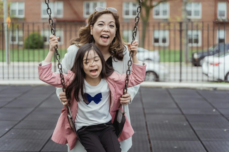 a woman and a little girl sitting on a swing, pexels contest winner, incoherents, asian descent, avatar image, schools, full frame image