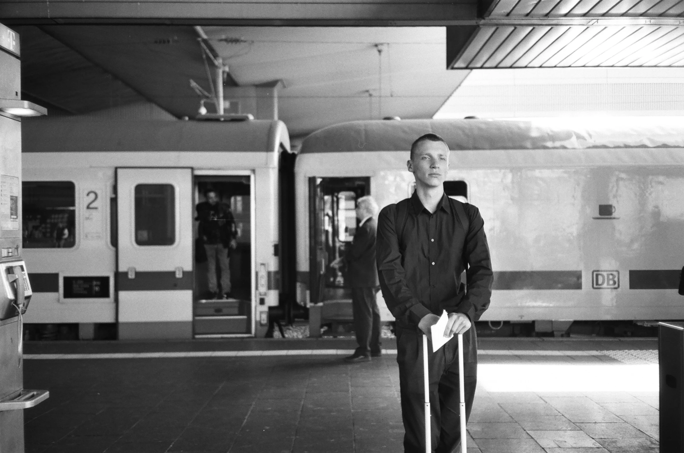 a man with a cane standing in front of a train, antipodeans, vitalik buterin, simone graci, waiting to strike, christophe szpajdel