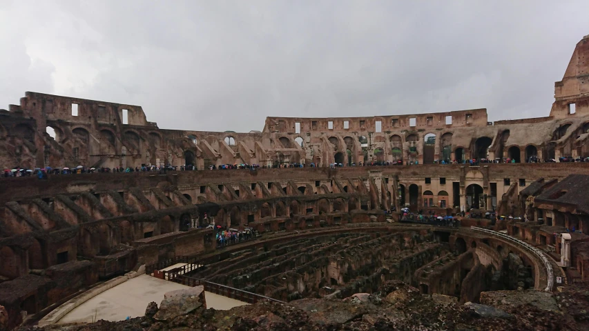 a view of the interior of the colossion in rome, a photo, pexels contest winner, renaissance, overcast day, 🦩🪐🐞👩🏻🦳, in a gladiators arena landscape, looking sad