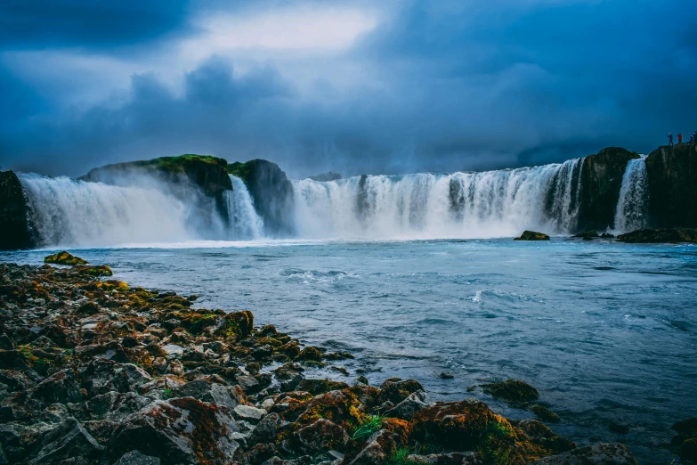 a waterfall in the middle of a body of water, by Jesper Knudsen, pexels contest winner, hurufiyya, thumbnail, ancient majestic, conde nast traveler photo