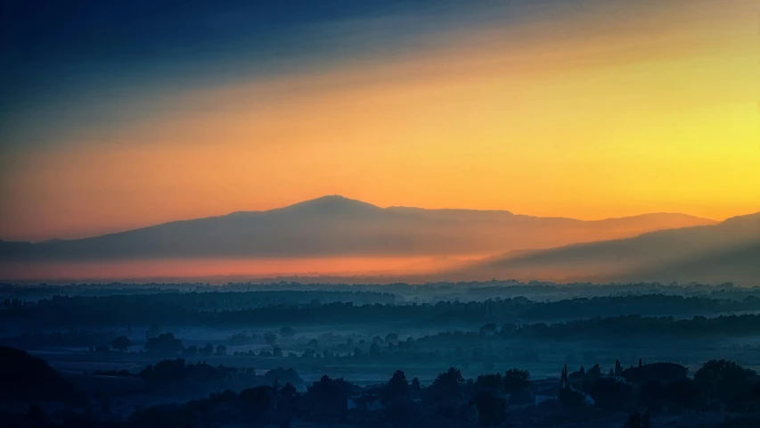 the sun is setting over the mountains in the distance, by Adam Marczyński, pexels contest winner, romanticism, colorful haze, marbella landscape, volcano fog, today\'s featured photograph 4k