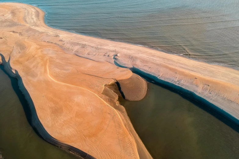 a large body of water next to a sandy beach, by Eglon van der Neer, pexels contest winner, land art, river delta, brown durand, flight, slide show