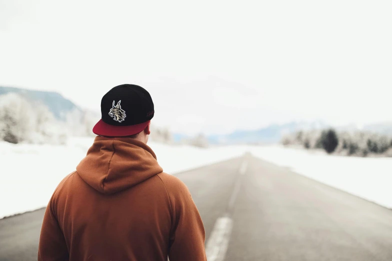 a man standing on the side of a snow covered road, trending on pexels, visual art, wearing a backwards baseball cap, 9 9 designs, back of head, avatar image