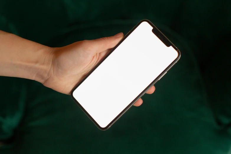 a close up of a person holding a cell phone, pexels, realism, full view blank background, iphone 1 3 pro max, glowing screen, white porcelain skin