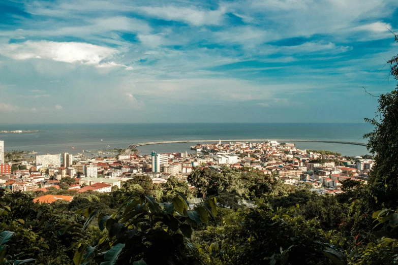 a view of a city from the top of a hill, by Daniel Lieske, pexels contest winner, sumatraism, views to the ocean, avatar image