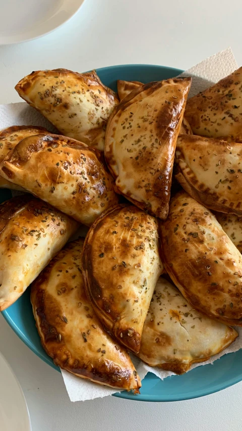 a close up of a plate of food on a table, calzone zone, taken on iphone 14 pro, square, 6 pack